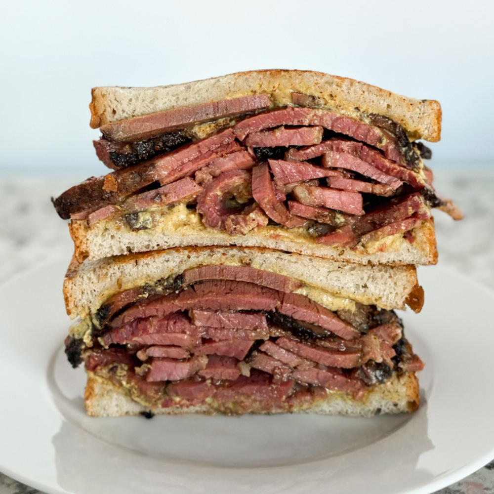 Beantown Pastrami Company stacked sandwich cut in half