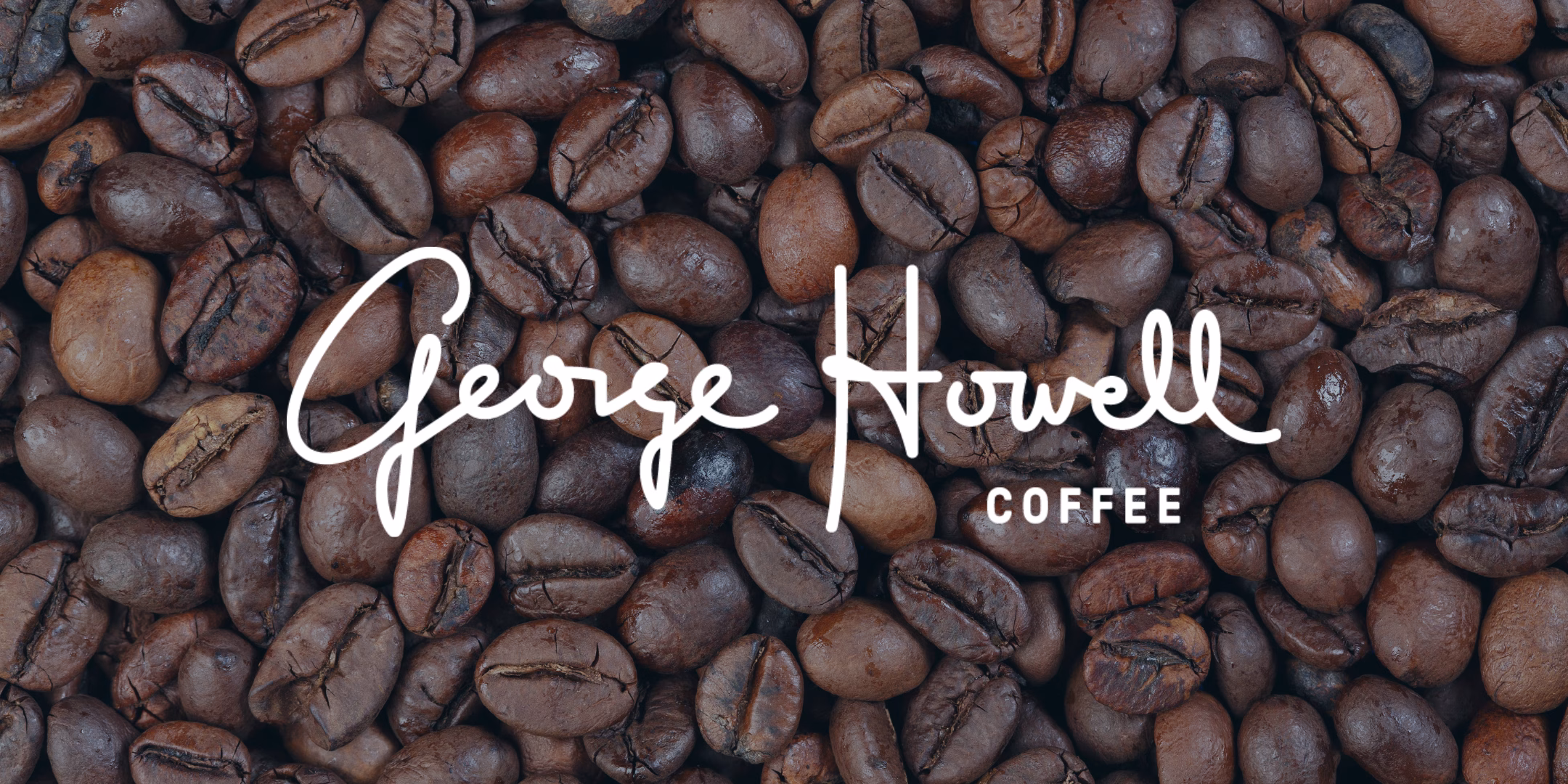 George Howell Coffee logo over whole coffee beans